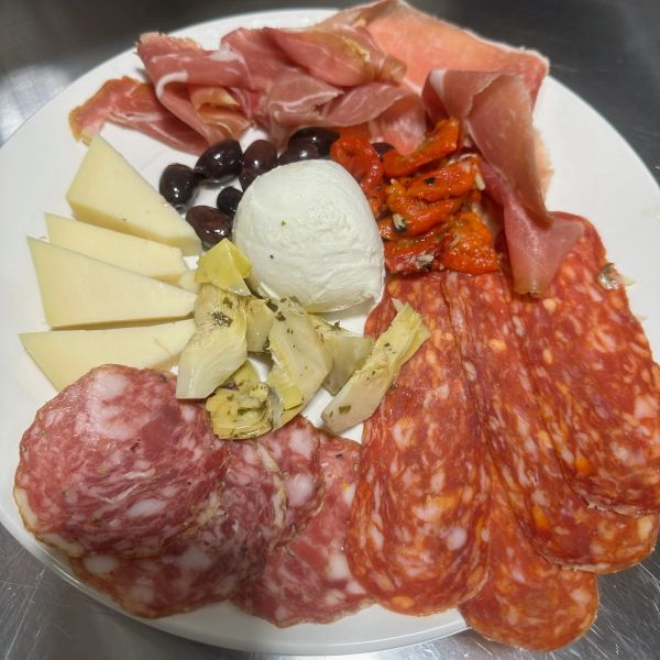Nonno Ciccio's pizza pasta Italian dish slices of meat, cheese and other Italian ingredients.