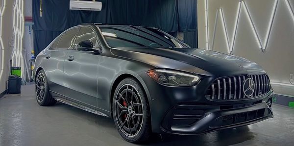 Sleek black Mercedes sedan in a garage.