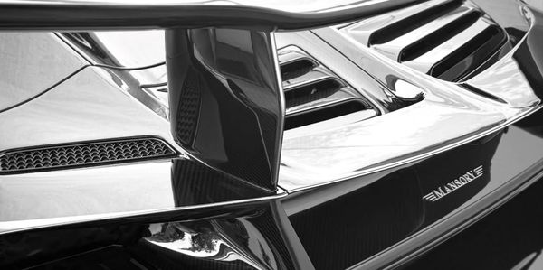 Close-up of a black Mansory car detail.
