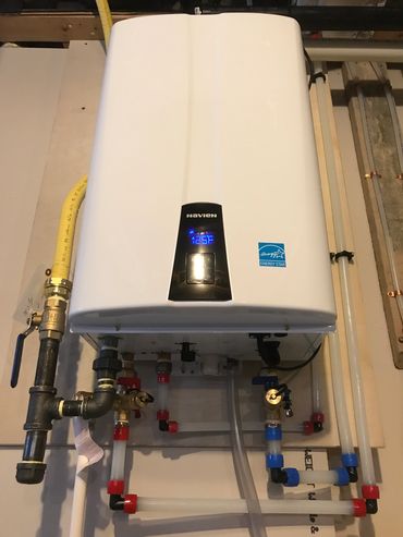 Navien tankless water heater installed by Signature Plumbing & Heating in Regina for efficiency.