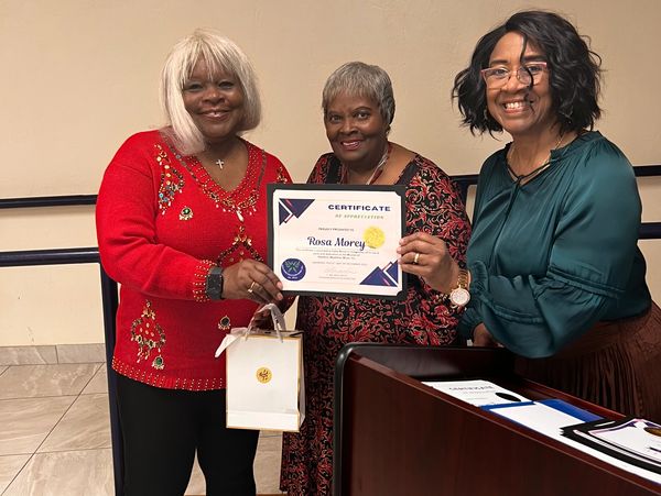 All Smiles as Rosa Morey accepts her Certificate of Appreciation from Shirley Thompson Member of the