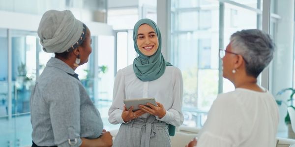 Smiling professional women collaborating Dubai UAE diversity inclusion HR consulting GCC region.