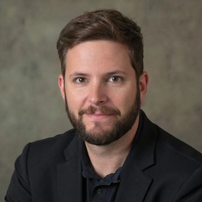 Portrait of a man with a beard and short hair.