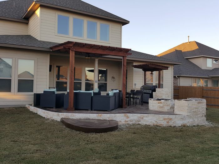 Concrete patio with pergola, bbq enclosure, fire pit, stone bench, masonry