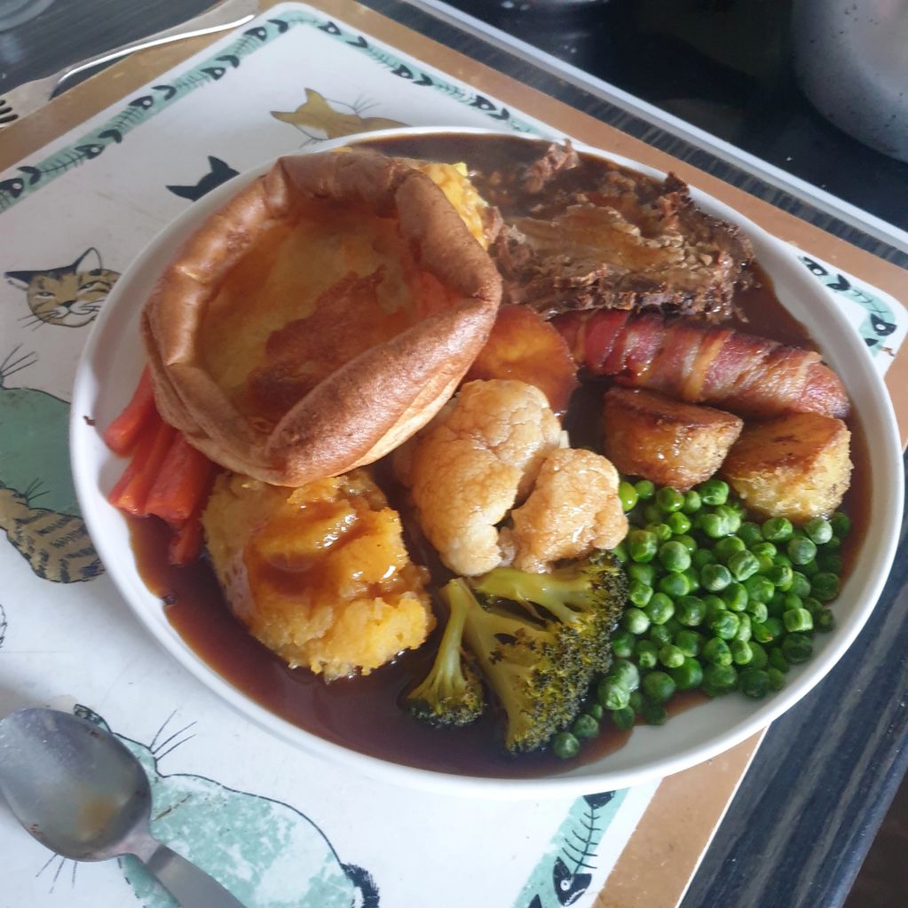 Roast Beef dinner with roast and mashed potatoes, carrot, swede, broccoli, cauliflower, peas and a p