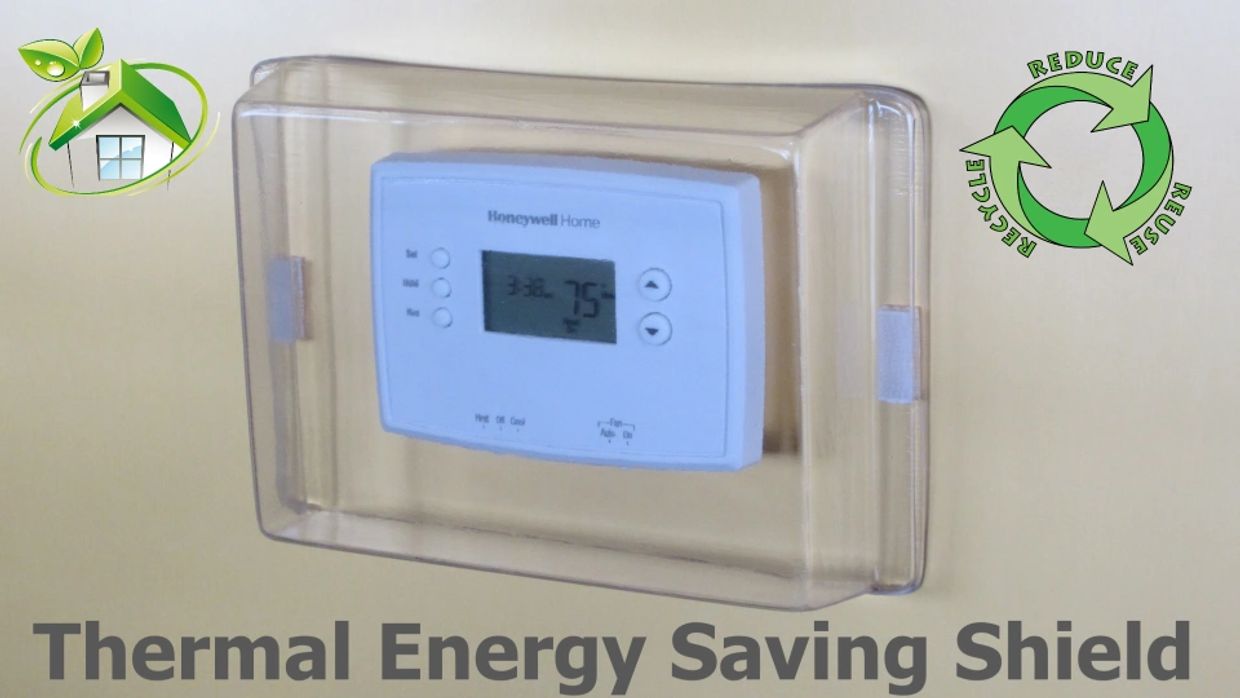 Honeywell thermostat with a clear thermal energy saving shield for eco-friendly use.