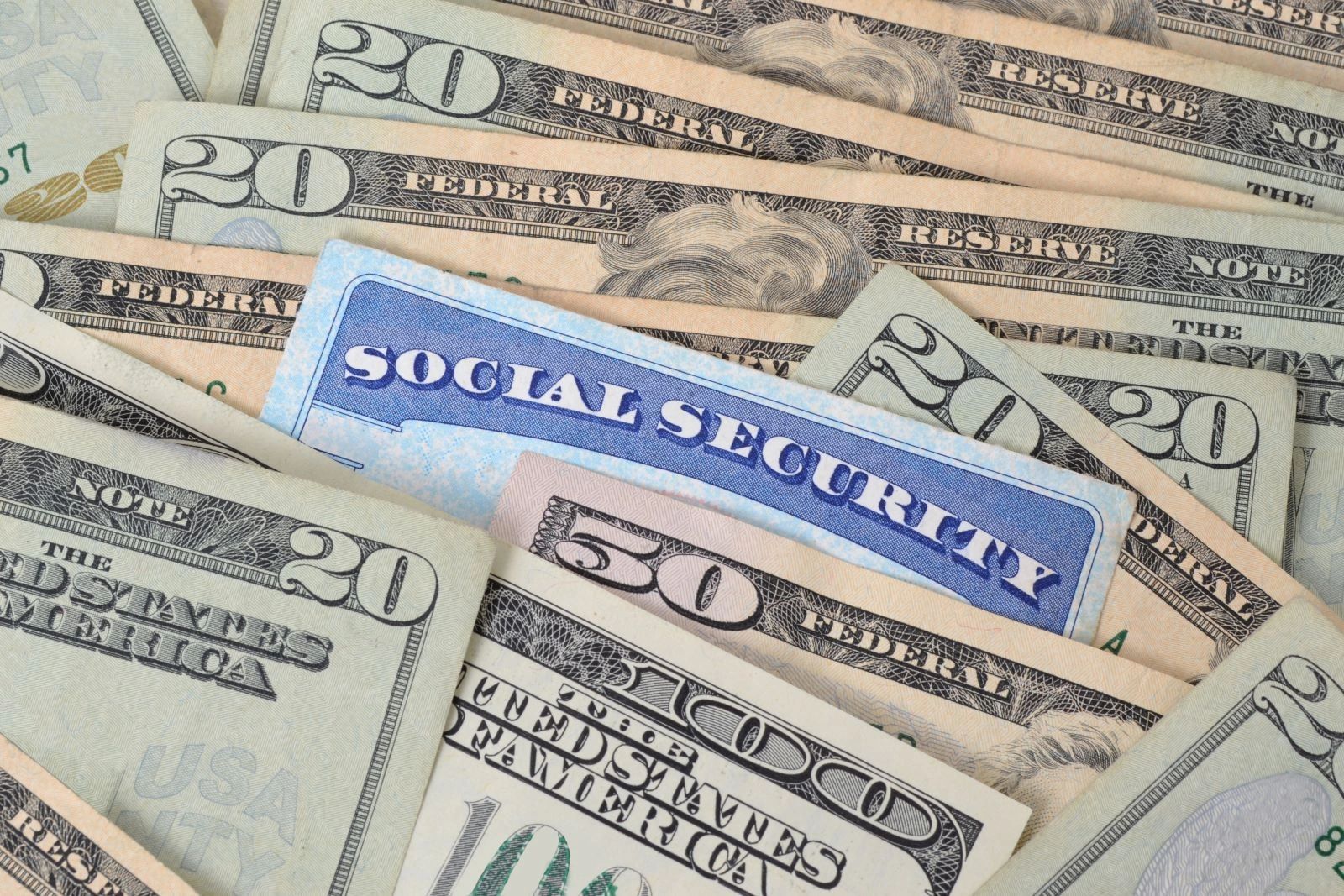 Image of various amounts of dollar bills and a Social Security card laying in the middle.