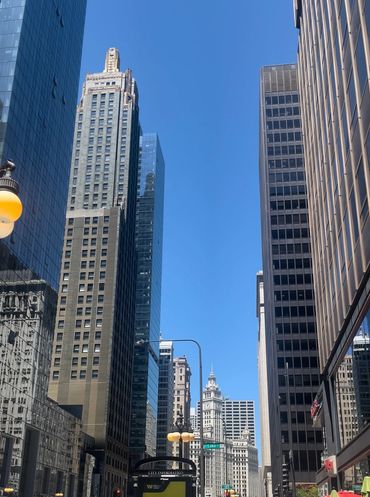 Tall buildings under clear blue sky in a city.