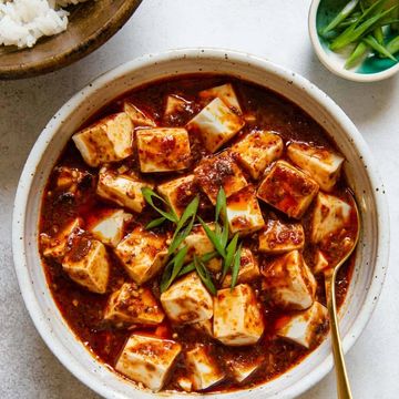 a bowl of mapo tofu with shallots