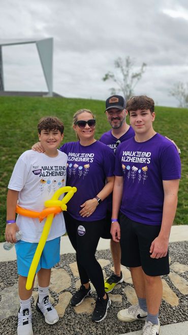 A smiling family standing together at a community charity event.