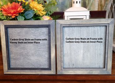 Two wooden frames showcasing different stain combinations: carbon grey with ebony and carbon grey with carbon grey.