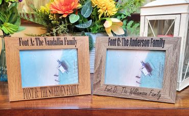 Two wooden photo frames showcasing different font styles for family names.