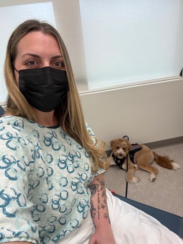 A service dog and his handler at a doctors office.