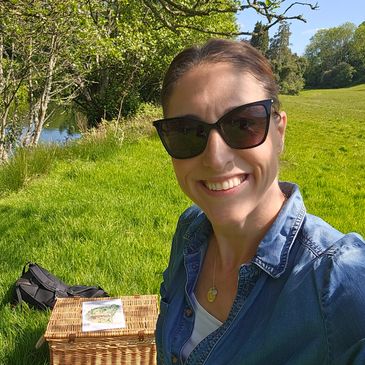 Beth Hammond Women's confidence and mindset coach sitting in field near river