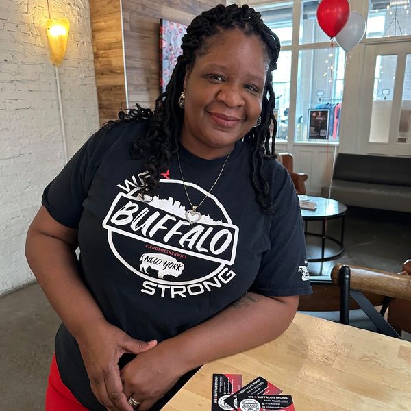 Smiling woman wearing a Buffalo Strong shirt.
