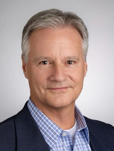 Professional headshot of a middle-aged man.