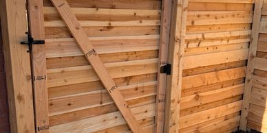Wooden door and walls with hinges in a structure.