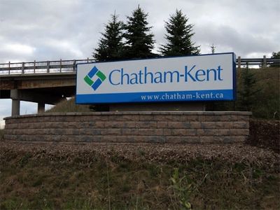Welcome sign for Chatham-Kent under a cloudy sky.