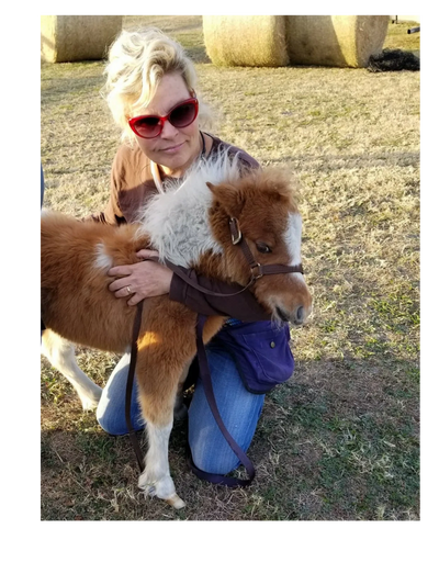 Heidi Herriott hugging a baby mini horse