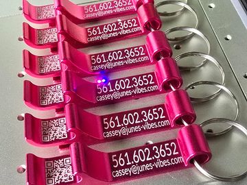 company bottle cap openers sitting on an Xtool f1 laser engraver platform