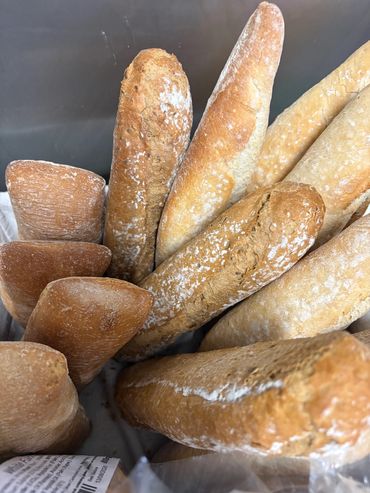 Close-up of various types of fresh bread loaves.