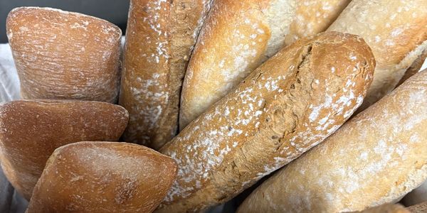 Close-up of various types of fresh bread loaves.