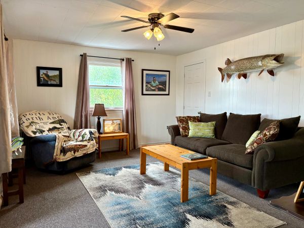 Cozy living room with a fish mount and comfortable seating.
