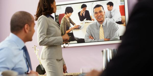 Business professionals engaged in a video conference meeting.