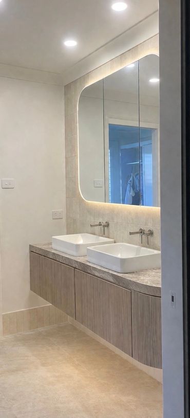 Backlit bathroom mirror lighting installed for modern vanity in Newcastle NSW