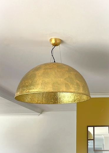 Modern gold pendant light installation in Newcastle home