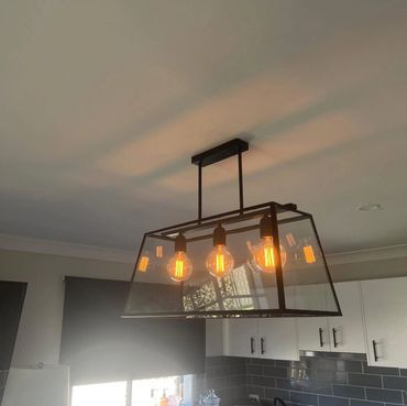 Feature pendant lighting installed above kitchen island in Newcastle