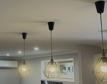 Pendant lighting installation over kitchen bench in Newcastle home