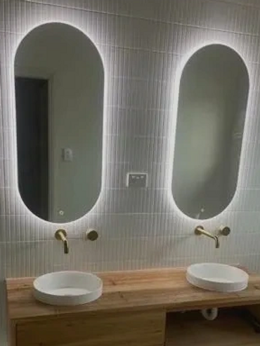 LED mirror lighting installation above double vanity in Newcastle bathroom renovation