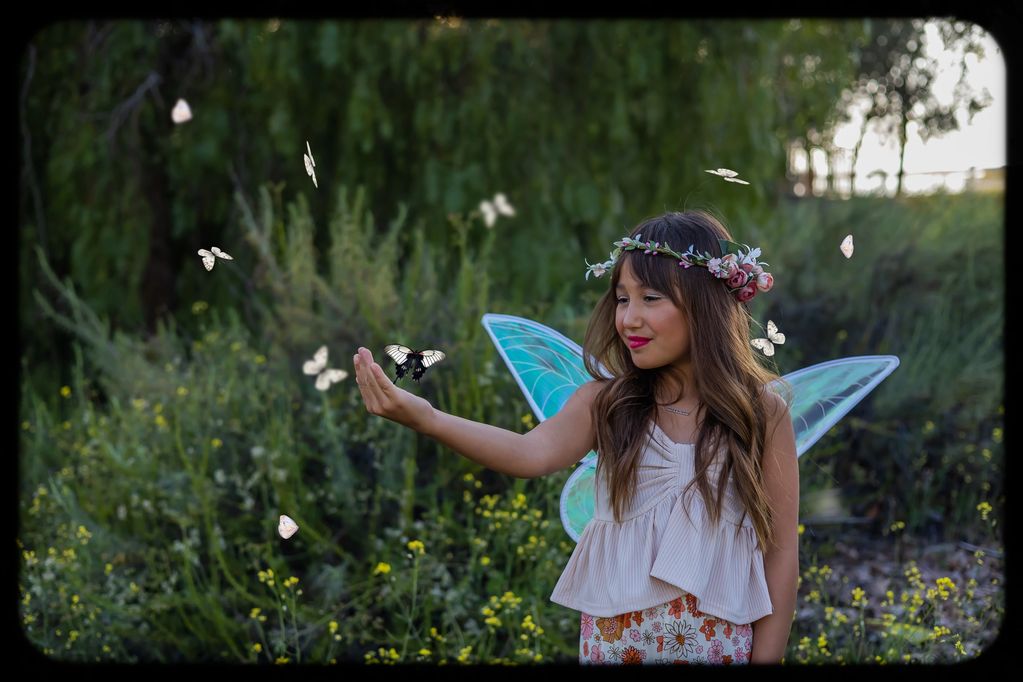 A sweet little fairy in a field of wildflowers. I added the butterflies