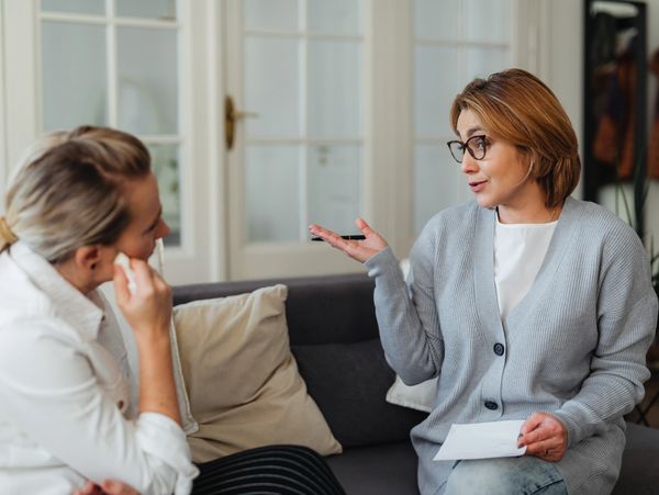 A counsellor talking with a patient on the couch