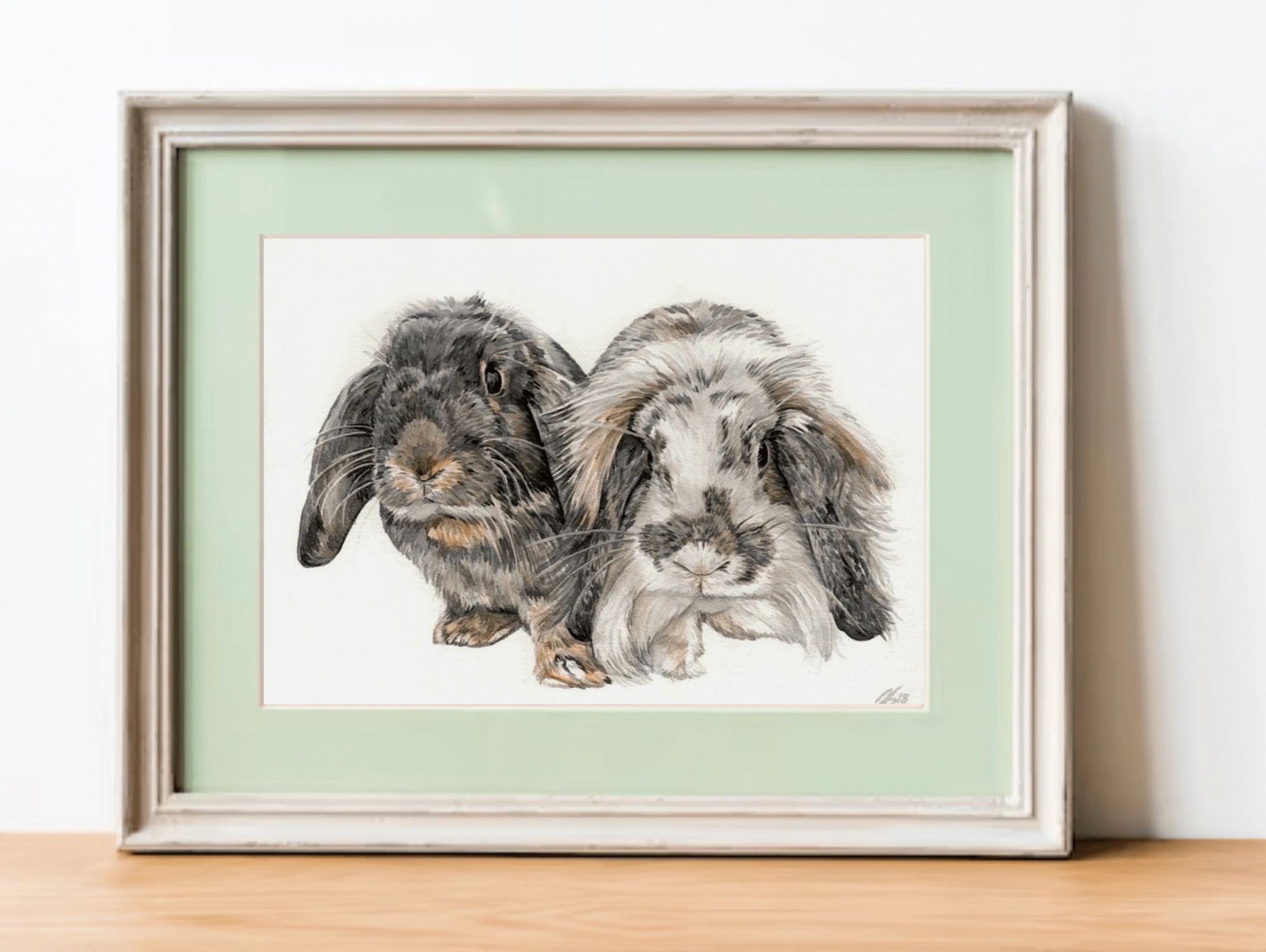 Watercolour pet portrait of two cute rabbits in a green frame