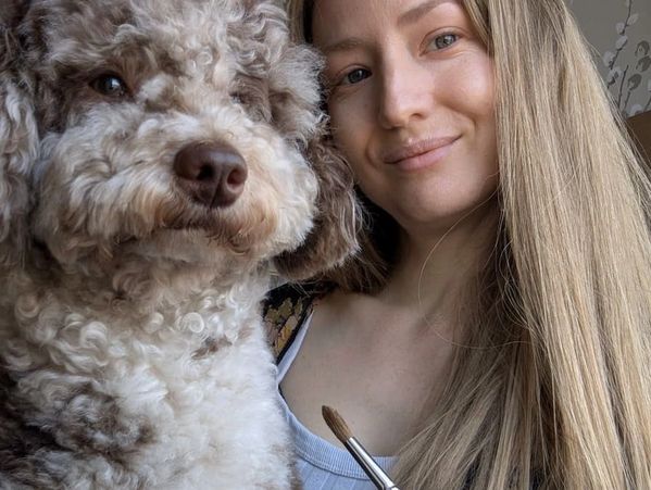 Pet portrait artist Jo Shepherd pictured with her Merle Miniature Poodle, Jasper