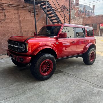Red Bronco with steps in background
