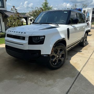 White Range Rover with part of house in background