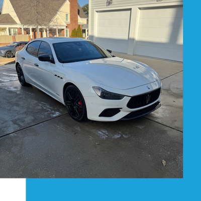 white Maserati in driveway