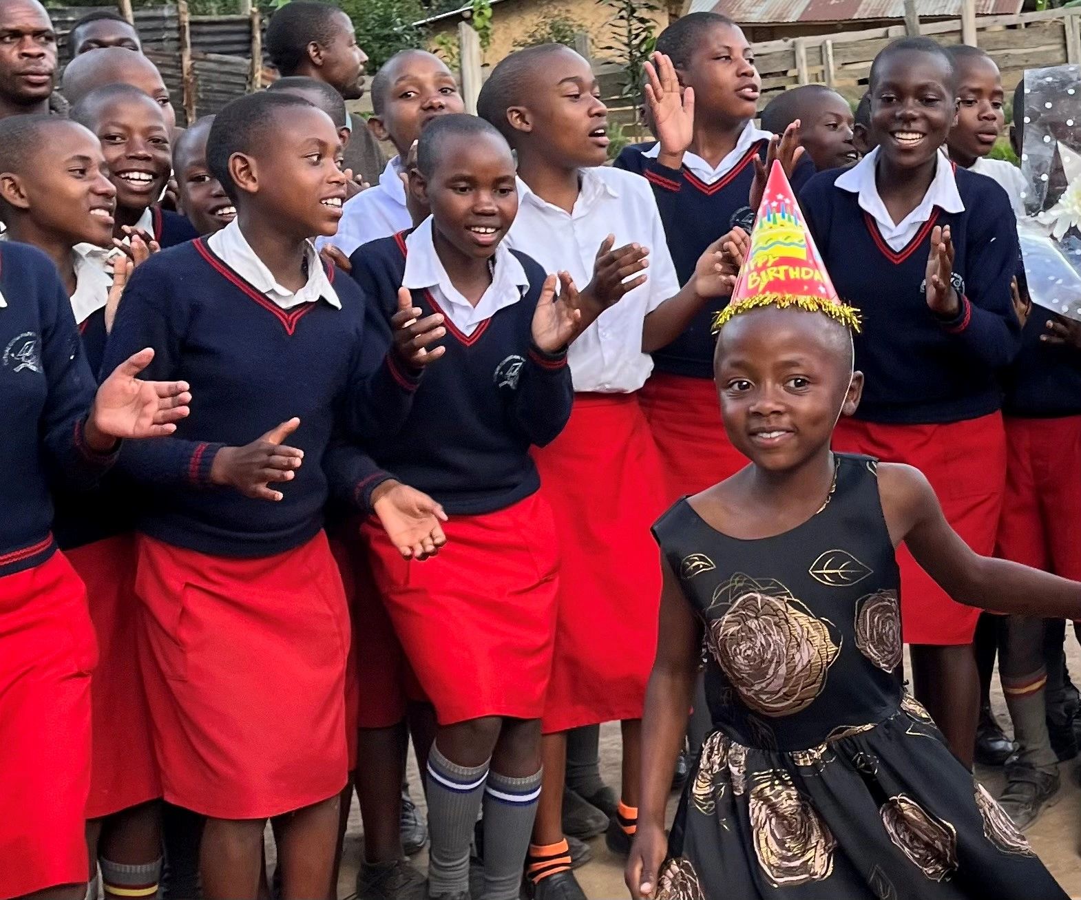 Group of girls celebrating a birthday outdoors.