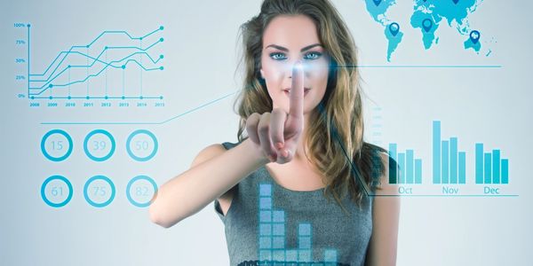 Woman interacting with digital data charts and graphs.