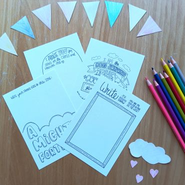 Creative coloring activity sheets with colored pencils and paper shapes.
