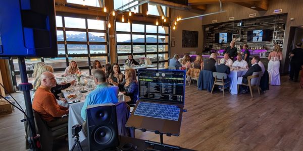 People enjoying great music from a DJ, eating and conversing in front of expansive Mountain View.