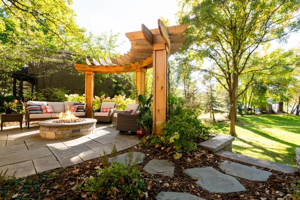 Curved Cedar Arbor and Stone Masonry Gas Fire Pit