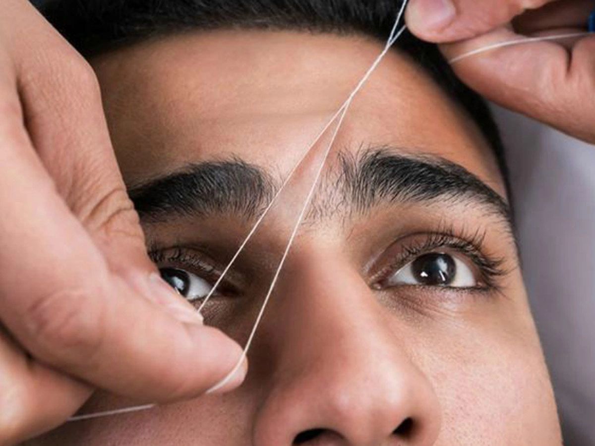 Eyebrows shaping and cleaning with thread.