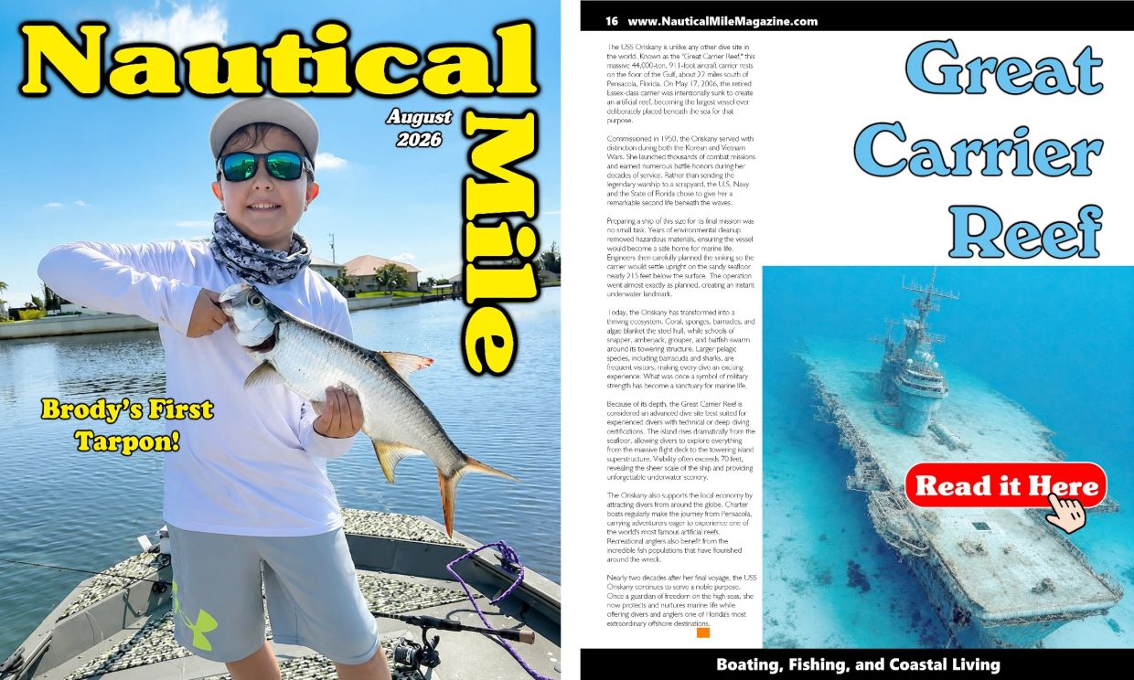 Boy holding a tarpon fish on a boat under clear blue sky.