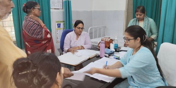 A busy hospital reception with staff attending to patients.