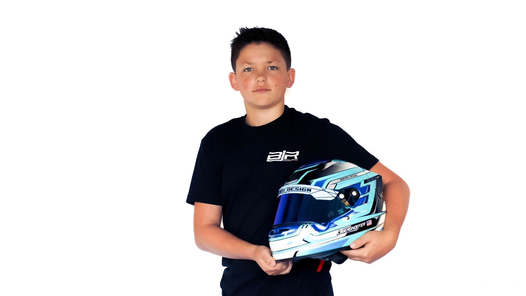 Young racer holding a helmet