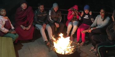 group of tourists enjoying born fire